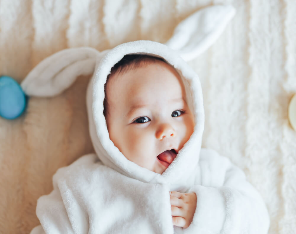 baby in rabbit suit smiling baby boy names